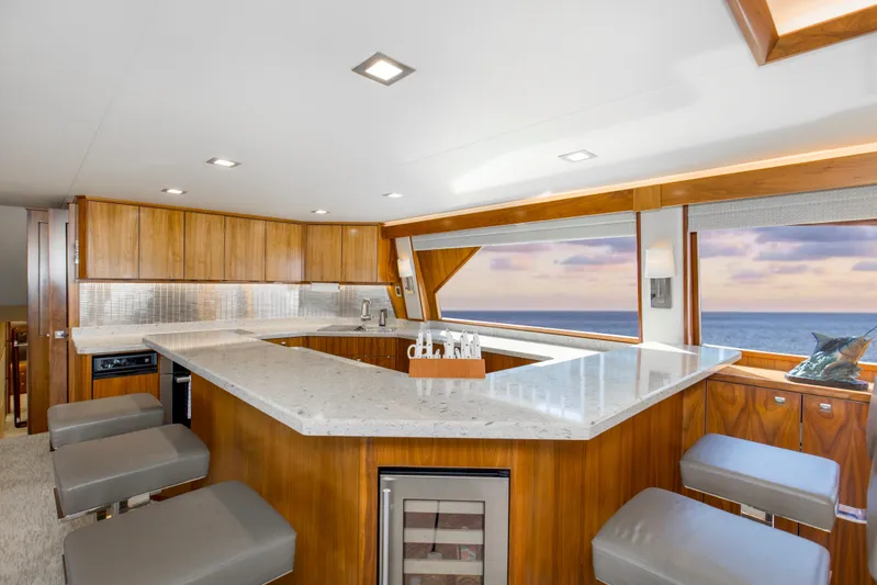 Touche Yacht Photos Pics Luxurious interior of 2016 Viking 92 Enclosed Bridge yacht with ocean view and modern kitchen.