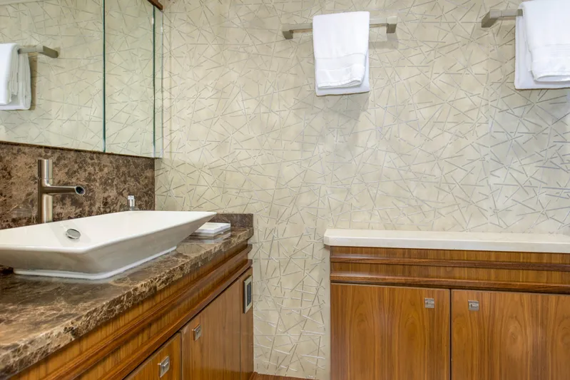 Touche Yacht Photos Pics Luxurious bathroom in 2016 Viking 92 Enclosed Bridge yacht with modern sink and elegant decor.