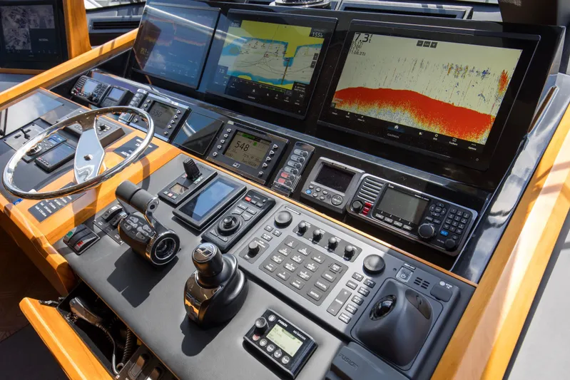 Touche Yacht Photos Pics Control panel of 2016 Viking 92 Enclosed Bridge yacht with advanced navigation systems.