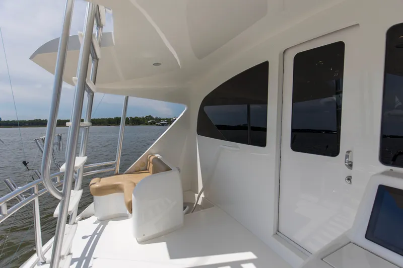 Touche Yacht Photos Pics 2016 Viking 92 Enclosed Bridge yacht deck with seating and water view.