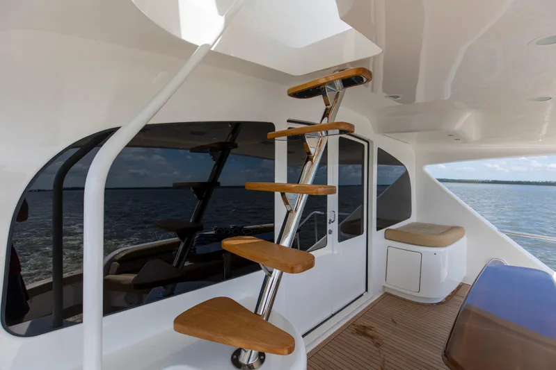 Touche Yacht Photos Pics 2016 Viking 92 Enclosed Bridge yacht with sleek staircase and ocean view.