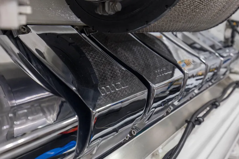 Touche Yacht Photos Pics Engine components of a 2016 Viking 92 Enclosed Bridge yacht, showcasing polished metal details.