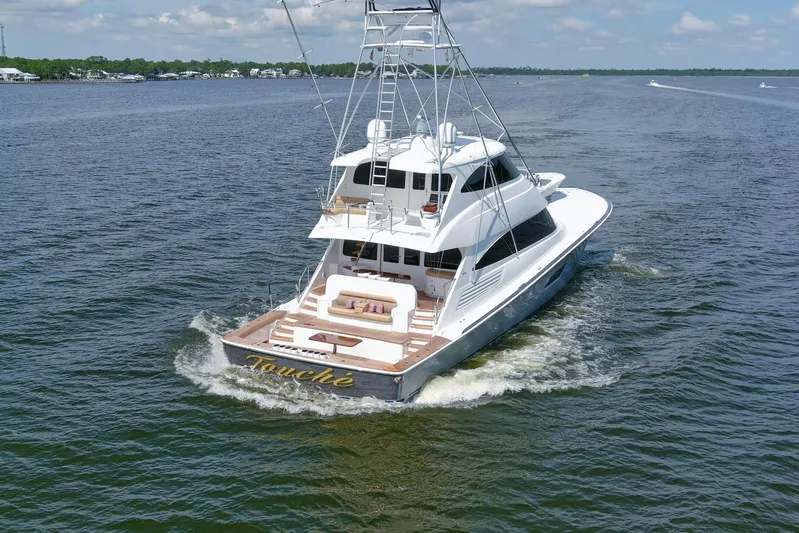 Touche Yacht Photos Pics 2016 Viking 92 Enclosed Bridge yacht cruising on open water.