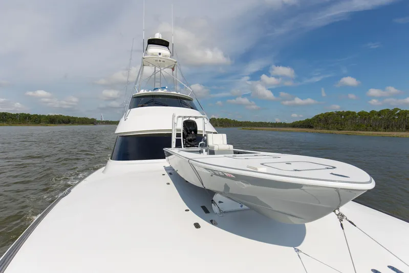 Touche Yacht Photos Pics 2016 Viking 92 Enclosed Bridge yacht cruising on a scenic waterway under a blue sky.