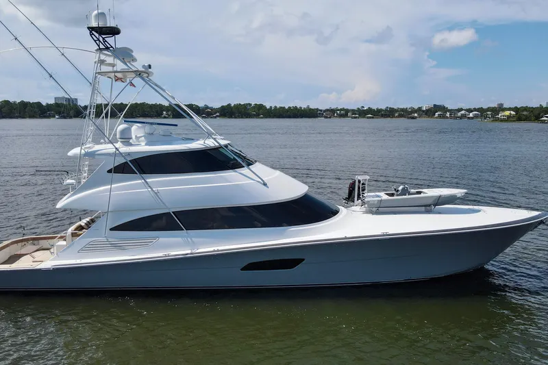 Touche Yacht Photos Pics 2016 Viking 92 Enclosed Bridge yacht on calm water, side view.