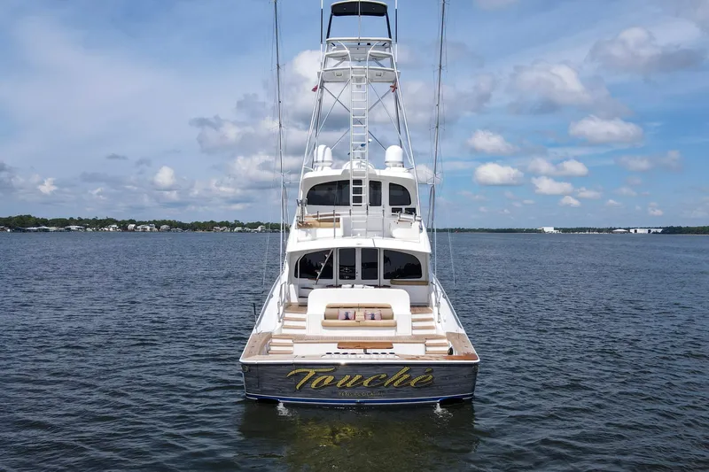 Touche Yacht Photos Pics 2016 Viking 92 Enclosed Bridge yacht on calm water under a blue sky.