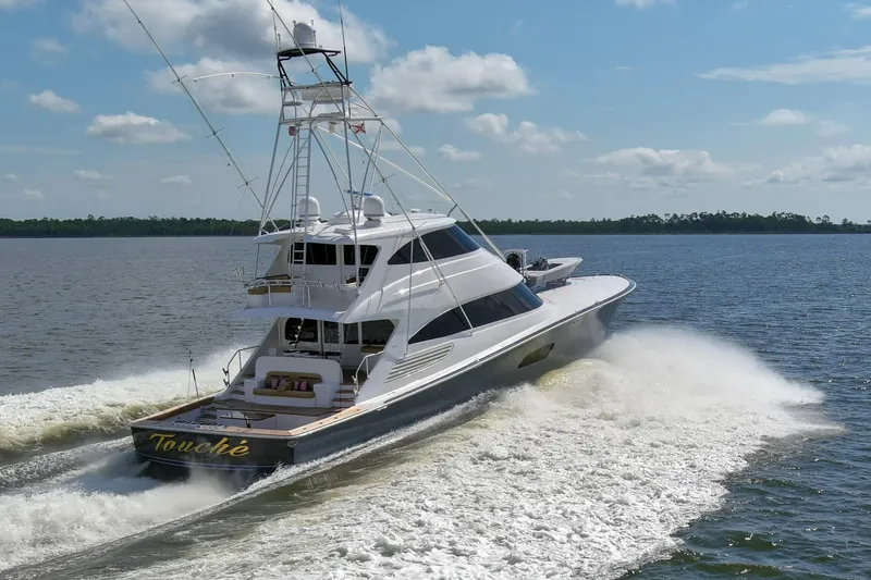 Touche Yacht Photos Pics 2016 Viking 92 Enclosed Bridge yacht cruising on open water under a clear sky.