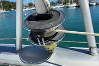 Sailboat rigging on a 2020 Leopard 45, with marina and palm trees in background.