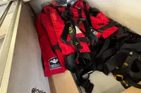 Red life jackets stored in a compartment on a 2020 Leopard 45 boat.