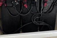 Battery compartment of a 2020 Leopard 45 yacht with connected cables.