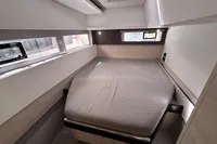 Modern bedroom interior in a 2020 Leopard 45 yacht, featuring a cozy bed and sleek design.