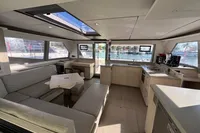 Luxurious interior of a 2020 Leopard 45 catamaran with modern kitchen and seating area.