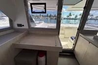 Interior view of a 2020 Leopard 45 yacht with marina and palm trees outside.