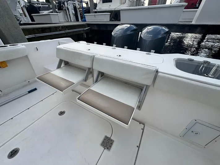  Yacht Photos Pics 2011 Everglades 320 Center Console boat with foldable seating and dual outboard motors.