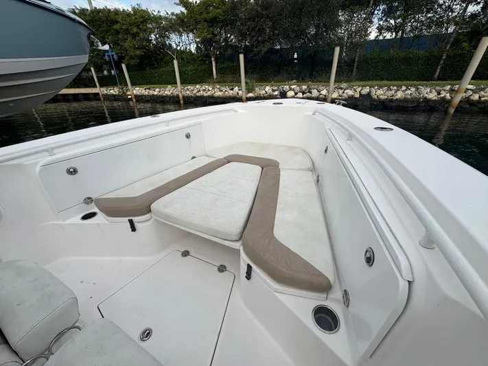  Yacht Photos Pics 2011 Everglades 320 Center Console boat with spacious seating area, docked by the water.