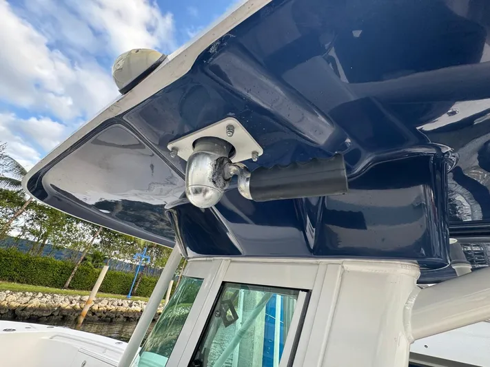  Yacht Photos Pics Close-up of Everglades 320 Center Console boat's T-top handle, 2011 model, against a cloudy sky.