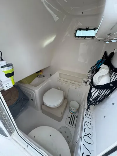  Yacht Photos Pics Interior of 2011 Everglades 320 Center Console boat with compact bathroom amenities.