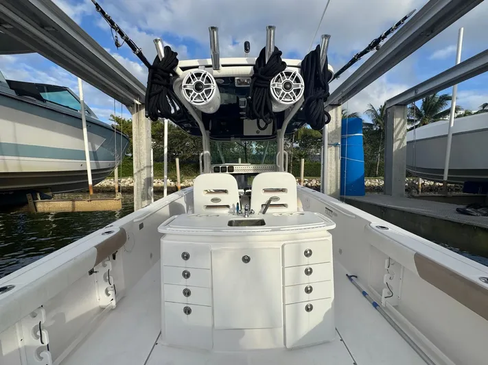  Yacht Photos Pics 2011 Everglades 320 Center Console boat docked, featuring fishing equipment and storage compartments.