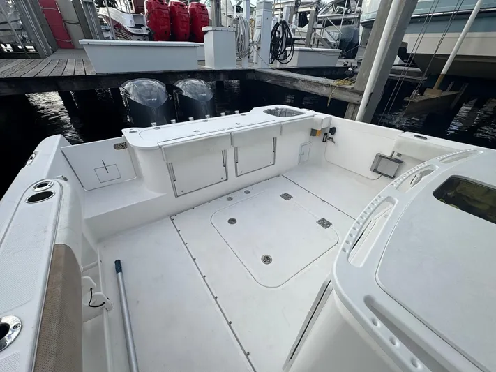  Yacht Photos Pics 2011 Everglades 320 Center Console boat interior with storage compartments and twin outboard motors.