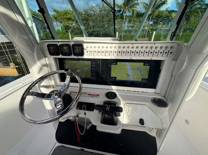  Yacht Photos Pics 2011 Everglades 320 Center Console boat dashboard with steering wheel and navigation screens.