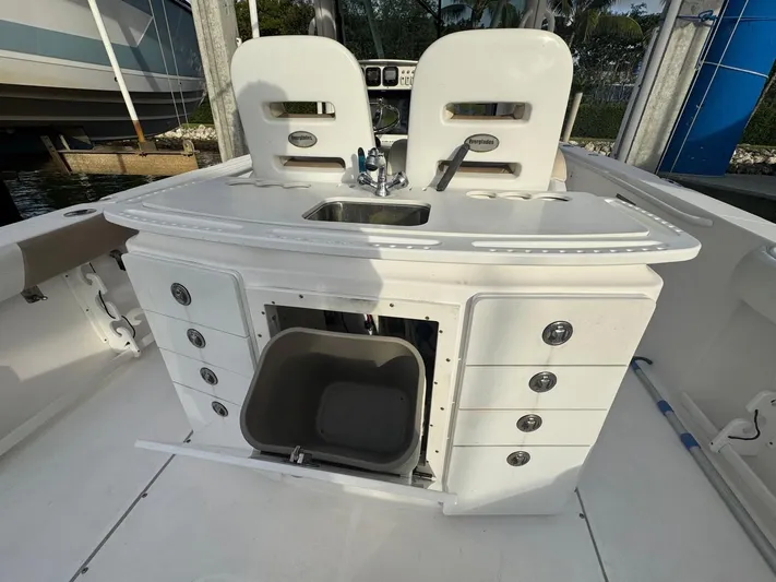  Yacht Photos Pics 2011 Everglades 320 Center Console boat interior with storage and sink.