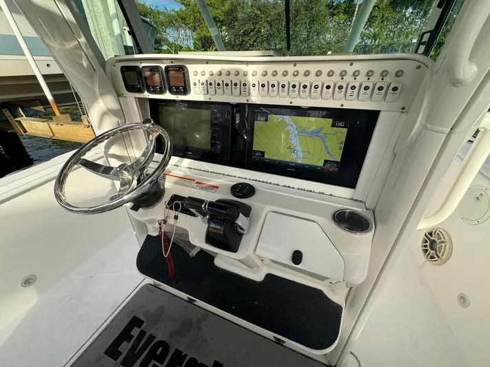  Yacht Photos Pics 2011 Everglades 320 Center Console boat dashboard with navigation system and steering wheel.