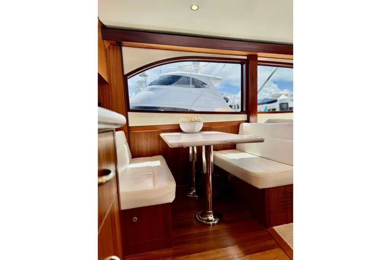  Yacht Photos Pics Interior of 2013 Hatteras GT60 yacht with elegant dining area and large window view.