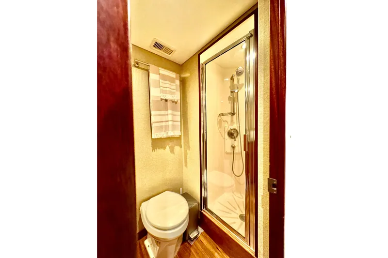  Yacht Photos Pics Luxurious bathroom in 2013 Hatteras GT60 yacht with shower and toilet.