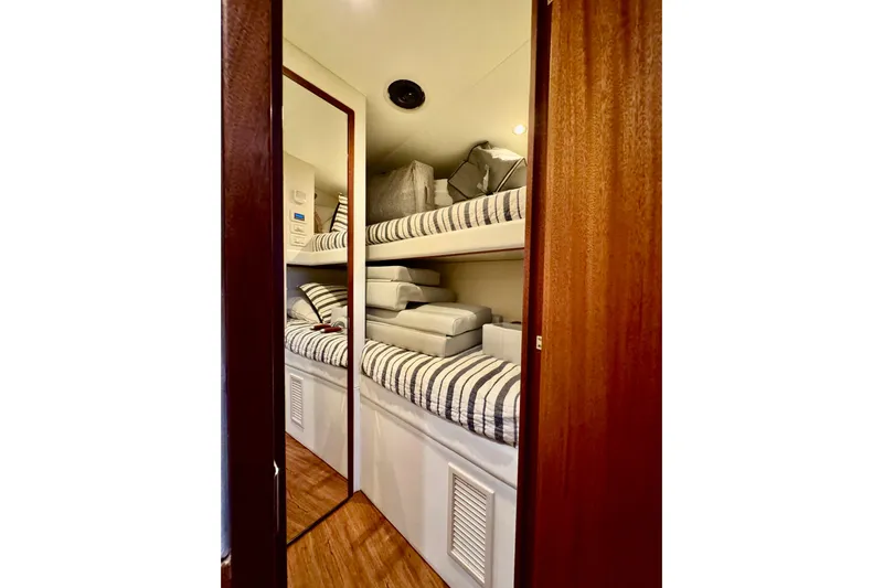  Yacht Photos Pics 2013 Hatteras GT60 yacht interior with bunk beds and striped bedding.