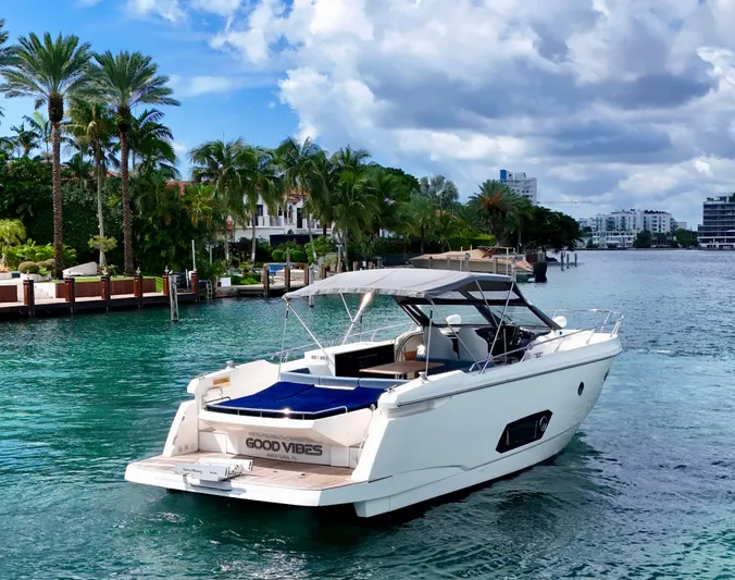  Yacht Photos Pics Luxury Absolute 40 yacht cruising in tropical waters, surrounded by palm trees and waterfront homes.