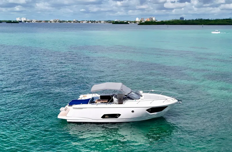  Yacht Photos Pics 2014 Absolute 40 yacht on turquoise water with city skyline in background.