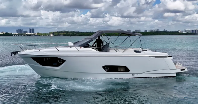  Yacht Photos Pics 2014 Absolute 40 yacht cruising on a serene, blue waterway under a cloudy sky.