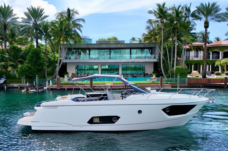  Yacht Photos Pics Luxury Absolute 40 yacht docked near modern waterfront mansion, surrounded by palm trees.