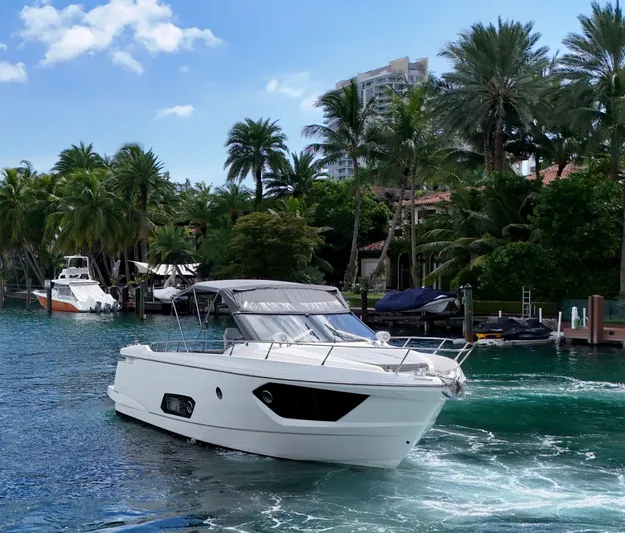  Yacht Photos Pics Luxury Absolute 40 yacht cruising in tropical waters, surrounded by lush palm trees.
