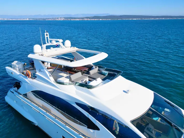 Hubo Yacht Photos Pics Luxurious 2016 Azimut 84 yacht cruising on clear blue ocean waters.