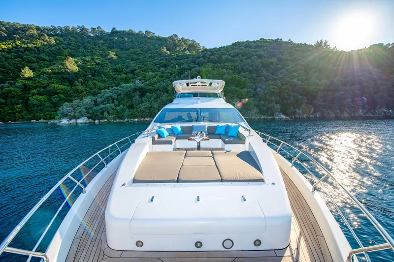 Hubo Yacht Photos Pics Luxurious 2016 Azimut 84 yacht cruising on serene waters with lush green hills in the background.