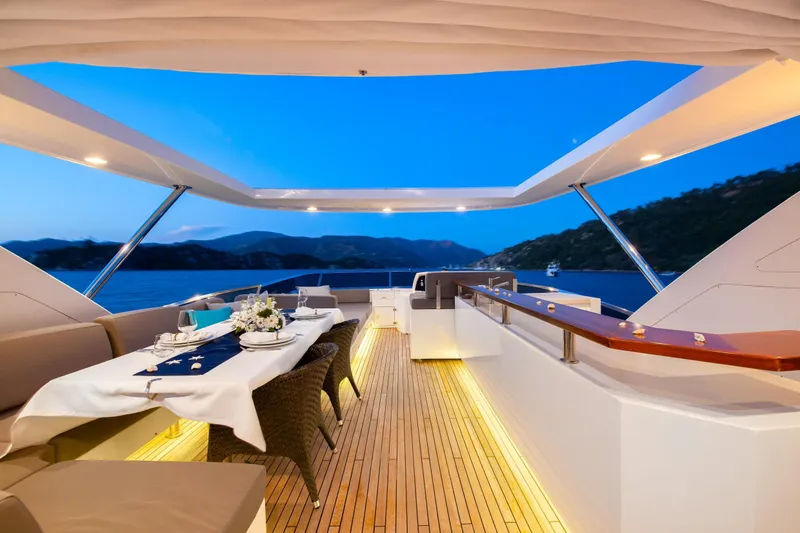 Hubo Yacht Photos Pics Luxurious 2016 Azimut 84 yacht deck with elegant dining setup and scenic ocean view.