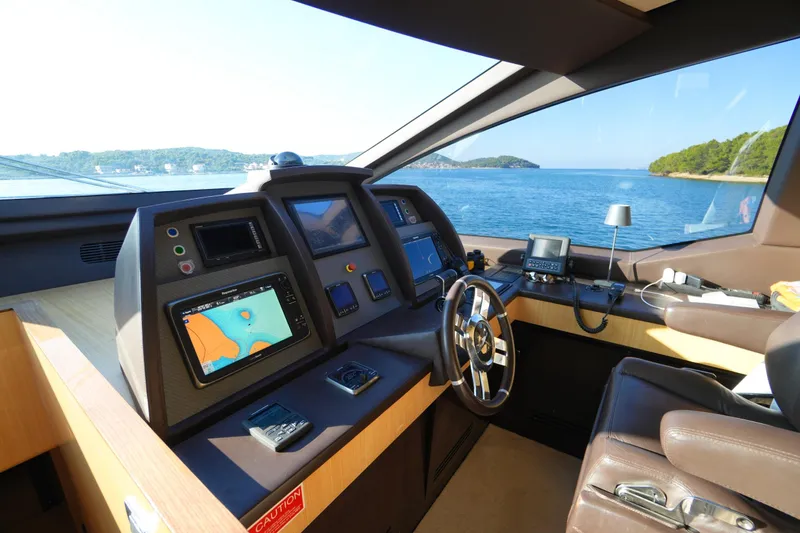 Hubo Yacht Photos Pics Helm of 2016 Azimut 84 yacht with navigation screens and ocean view.