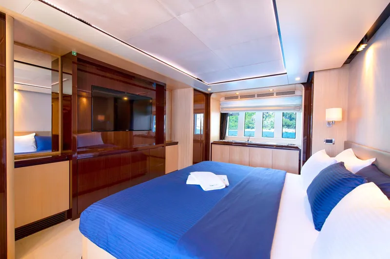 Hubo Yacht Photos Pics Luxurious bedroom interior of 2016 Azimut 84 yacht with modern design and blue accents.