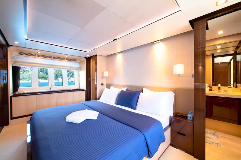 Hubo Yacht Photos Pics Luxurious bedroom interior on 2016 Azimut 84 yacht with blue bedding and modern design.