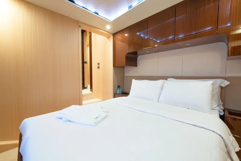 Hubo Yacht Photos Pics Luxurious bedroom interior of 2016 Azimut 84 yacht with modern wood paneling and elegant bedding.