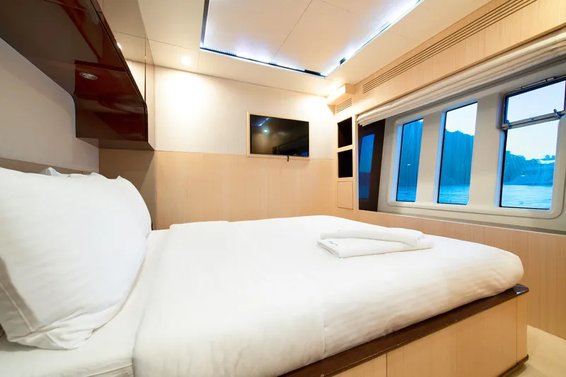 Hubo Yacht Photos Pics Luxurious bedroom interior of 2016 Azimut 84 yacht with large bed and scenic windows.