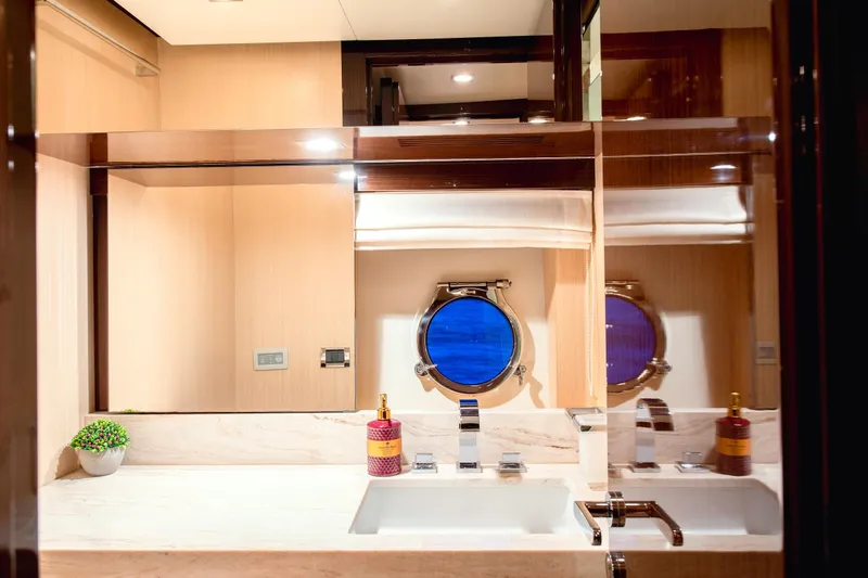 Hubo Yacht Photos Pics Luxurious bathroom interior of 2016 Azimut 84 yacht with modern fixtures and porthole window.