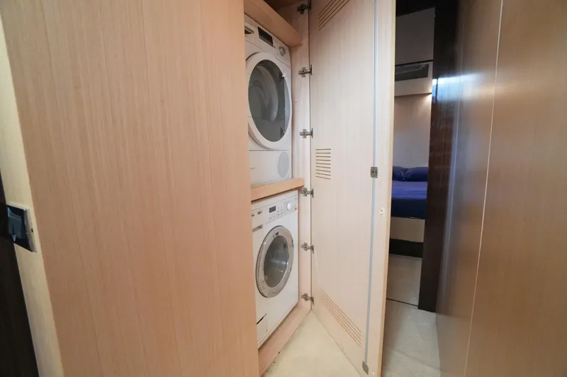 Hubo Yacht Photos Pics Laundry area with stacked washer and dryer on 2016 Azimut 84 yacht.