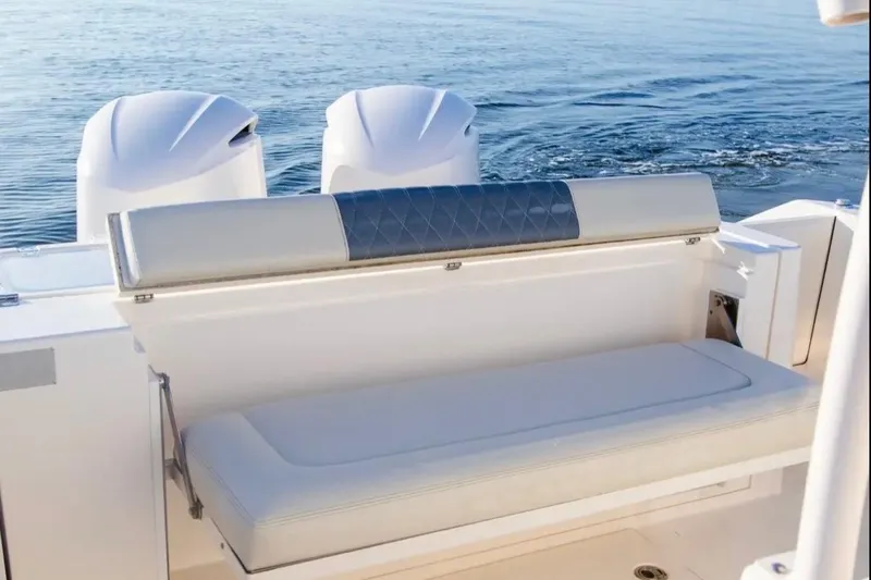  Yacht Photos Pics 2018 Cobia 320 Center Console boat with cushioned seating and dual engines on calm water.