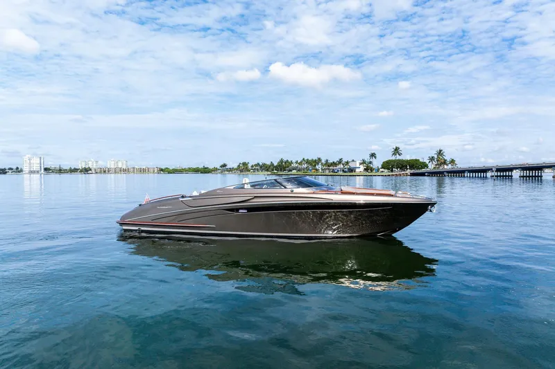 La Sirena Yacht Photos Pics 2014 Riva Rivarama luxury yacht on calm water under a partly cloudy sky.