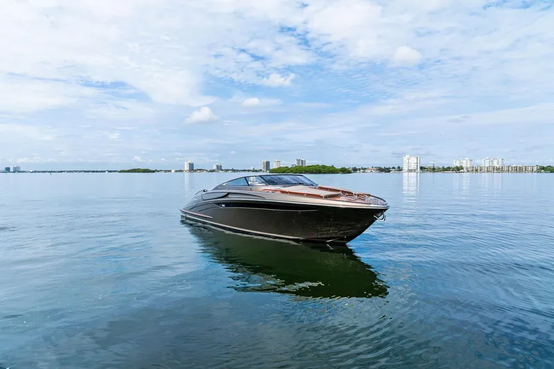 La Sirena Yacht Photos Pics 2014 Riva Rivarama luxury yacht on calm water with city skyline background.