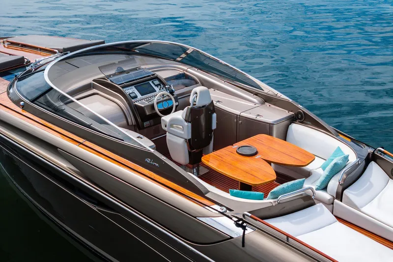 La Sirena Yacht Photos Pics Luxurious 2014 Riva Rivarama yacht with elegant seating and modern dashboard on calm water.