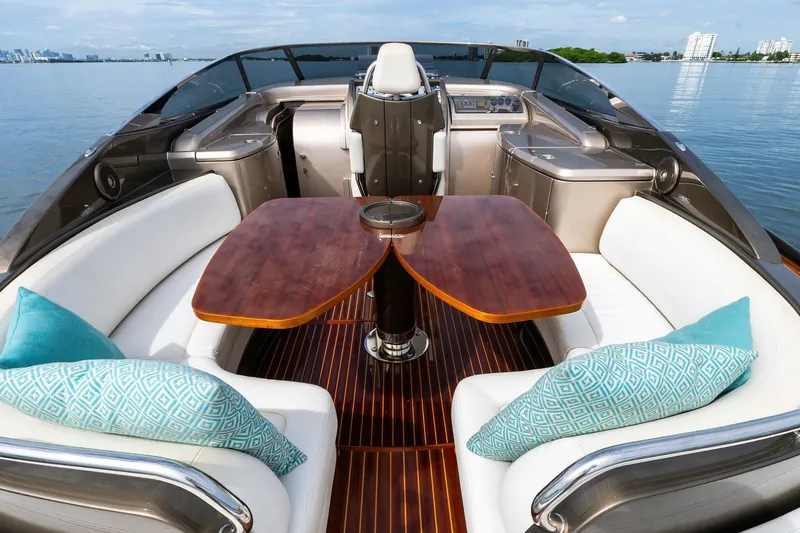 La Sirena Yacht Photos Pics Luxurious 2014 Riva Rivarama yacht interior with elegant seating and wooden table.