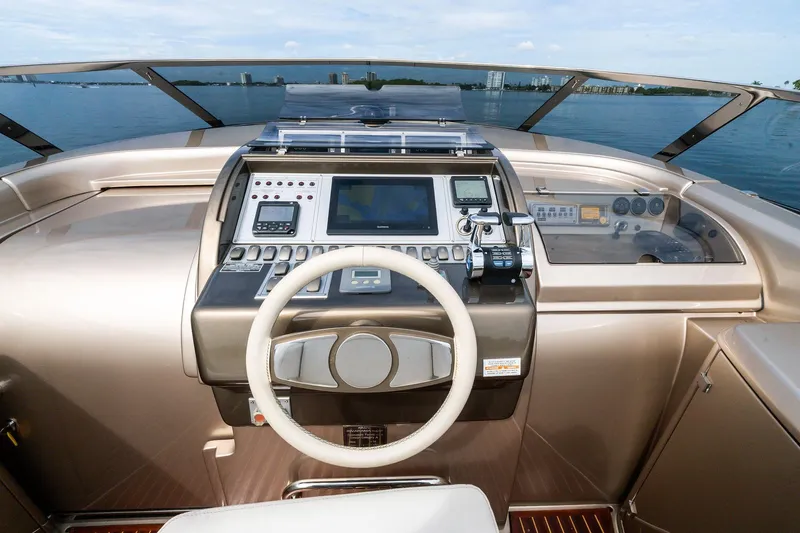 La Sirena Yacht Photos Pics 2014 Riva Rivarama yacht dashboard with steering wheel and navigation controls.